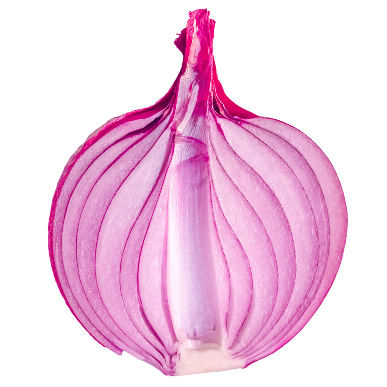 A red onion sliced in half over white background